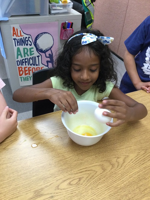 Child cracking eggs