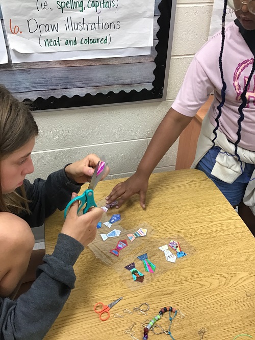 two children cutting out laminated ties