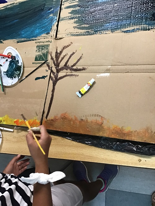 Child painting a tree