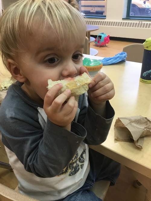 child eating their fresh baked bread