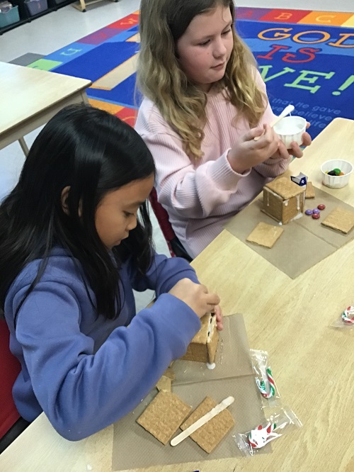 children building their gingerbread houses