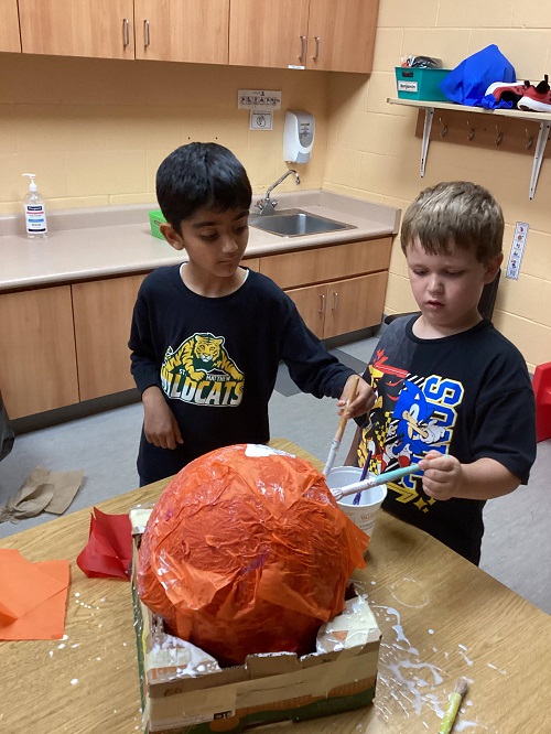 two children working on the head of their structure