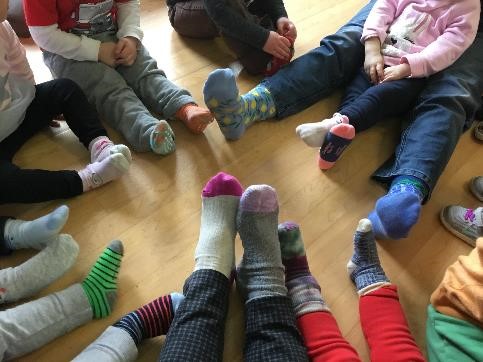 group in a circle showing their fun socks
