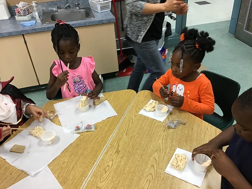 Children eating their rice Krispies treat.