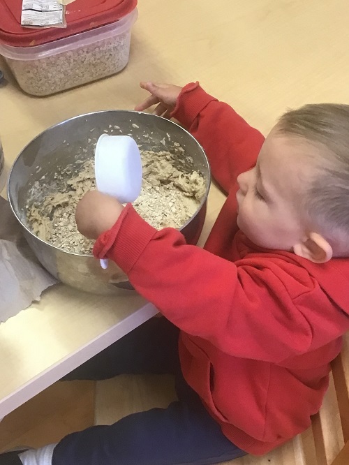 Child adding ingredient to the bowl