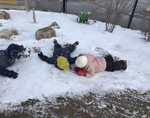 Children making snow angels.