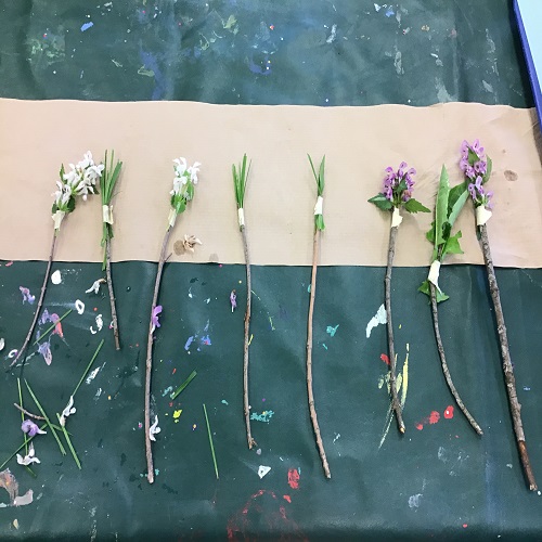 Table set up with created paint brushe fomr nature materials. 