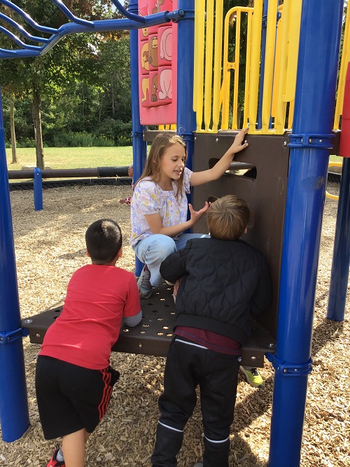 Children talking together on the playground. 