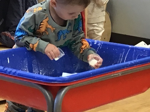Child engaged in the sensory bin.