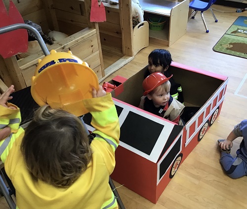 Children riding the created cardboard firetruck.