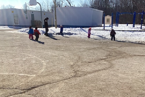 Children exploring walking on the slippery snow.