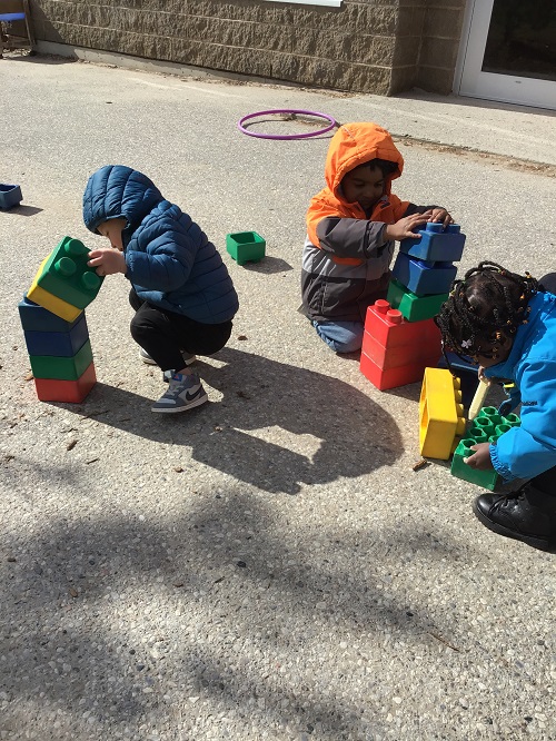 Children building with large blocks.
