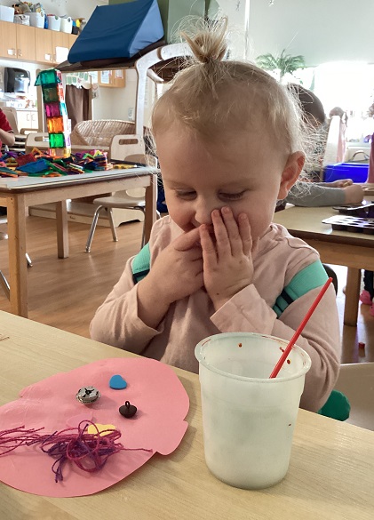 A preschool child admiring their artowrk