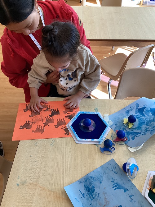 A toddler child using stamps