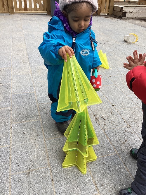 A child stacking star pylons into a pile
