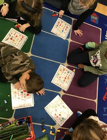 School Age children marking of the matching bingo picture