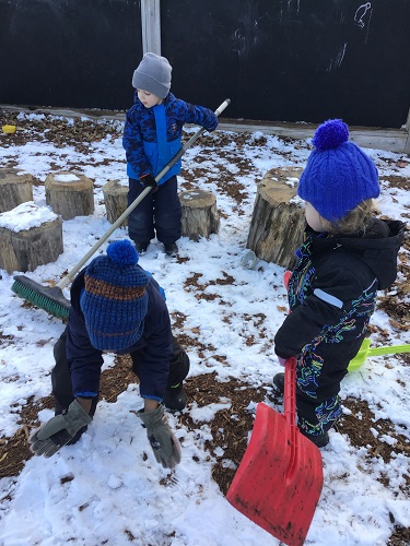 3 preschool children shoveling snow