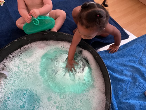 2 children playing at the water 