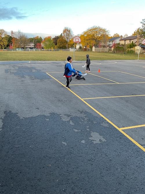 3 children playing hockey