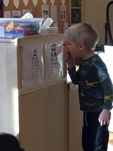 child observing an eye testing chart