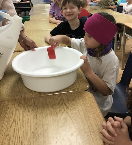 Children mixing ingredients together to make slime