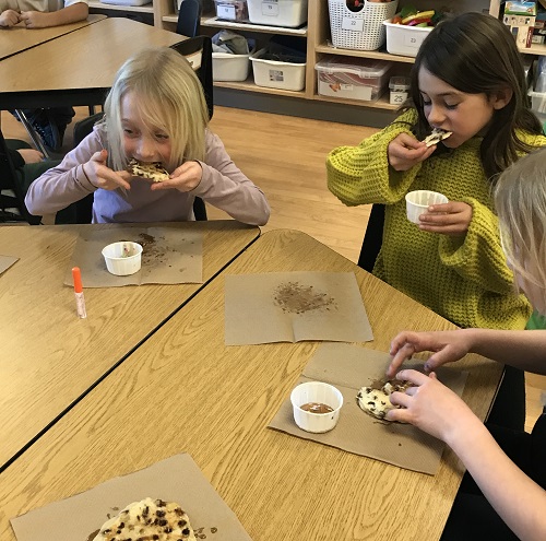 Three children eating pancakes