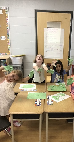 school aged children showing off their foamy hands