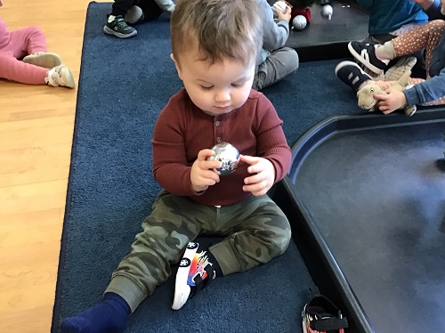 Toddler holding a christmas ball